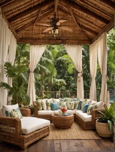 an outdoor living area with wicker furniture and curtains on the ceiling, covered in white drapes