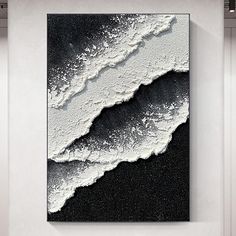 a black and white painting hanging on the wall