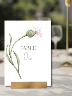 a card with an image of a flower and the words table one written on it