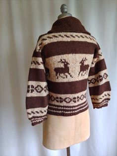 "A very rare 40s handknit wool cardigan with a reindeer motif Dark cocoa brown and ecru with hints of orange Shawl collar Metal zipper Not a heavy weight sweater Wider sleeves Handknit Bust - 34\" Hem - 34\" Sleeves - 15 1/2\" Cuff of sleeve across - 5\" Length - 21\" from back of collar to hem Excellent vintage condition Fresh and clean, ready to wear" Nordic Style Brown Cardigan For Fall, Brown Hand Knitted Winter Outerwear, Cozy Brown Cardigan With Fair Isle Pattern, Cozy Brown Outerwear With Fair Isle Pattern, Brown Fair Isle Pattern Winter Cardigan, Cozy Brown Fair Isle Pattern Cardigan, Orange Shawl, Cocoa Brown, Wool Cardigan