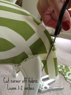 someone cutting fabric with scissors on top of a green and white chair cushion that has the words cut corner off fabric leave 1 - 2 inches