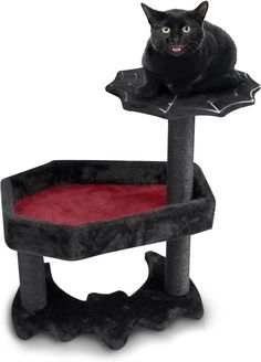 a black cat sitting on top of a scratching post with a red rug in front of it