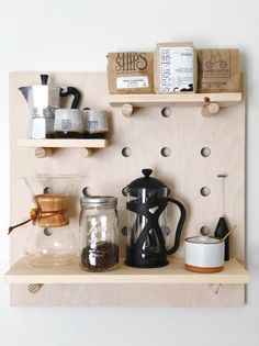 a wooden shelf with coffee cups and other items on it, including an espresso machine