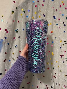 someone holding up a glitter tumbler with the word sparkle on it