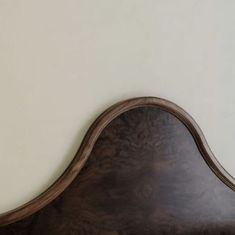 a wooden headboard against a white wall