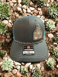 Welcome to DMDesignsPlus Etsy store! We sell a variety of handmade and personalized items perfect for holiday gifts, party stuffers, and more!  Product Information: Richardson 112 SnapBack Hat with Charcoal Grey/Teal Coloring, White tooled vegan leather patch with faux turquoise accents, Western Hat Richardson 112 SnapBack Hat---Charcoal Grey/Teal. White tooled vegan leather patch with faux turquoise accents.  Includes barbed wire removable hat chain.  Thank you for shopping small! Please remember to leave a review. It helps us a lot! Western Accessories Hats Women, Western Accessories Hats, Teal Country Hat, Kimes Ranch Hat Teal, Laser Leather Hats, Western White Baseball Hat, Hand Tooled Leather Hat, Leather Hat Patch Ideas, Western Trucker Hats