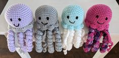 three crocheted octopus stuffed animals sitting next to each other