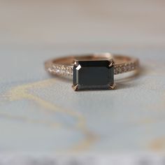 an engagement ring with a black diamond in the center