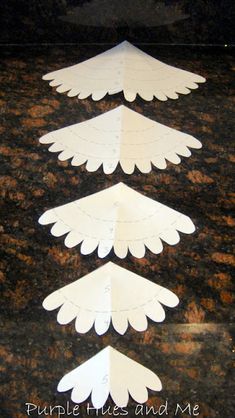 three white paper arrows on a marble surface