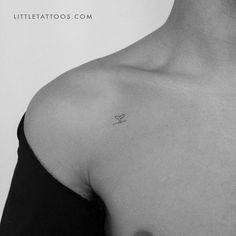 a black and white photo of a person with a small tattoo on their chest that says little tattoos