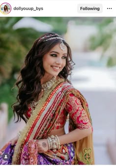 a woman in a colorful dress posing for the camera