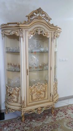 an ornate china cabinet with glass doors