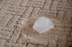 a white piece of ice sitting on top of a carpet