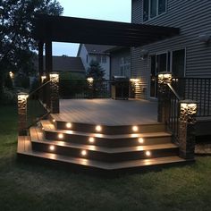 an outdoor deck with lights on the steps