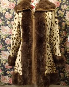 This coat is wildly fantastic in so many ways and will be a huge hit casual or dressed up. It has so much paxzaz going on from the fun animal print to the thick faux fur trim, gold button details, 70s collar and bell sleeves. Size small/medium Measurements: 34' long Shoulder to shoulder 16' Arms 22' Bell sleeves 8' Waist 15.5' Pit to pit 18' Light to Medium weight Made in Scotland Furrier cleaning recommended Fall Leopard Print Fur Coat With Faux Fur Lining, Fitted Retro Fur Coat For Fall, Leopard Print Fur Coat With Faux Fur Trim, Retro Fitted Brown Fur Coat, Retro Brown Fitted Fur Coat, Vintage Leopard Print Winter Outerwear, Fitted Faux Fur Outerwear In Leopard Print, Vintage Leopard Print Outerwear For Winter, Fitted Leopard Print Faux Fur Outerwear