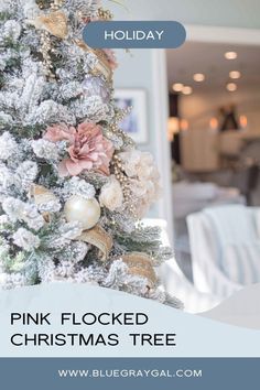 a white christmas tree with pink and gold ornaments