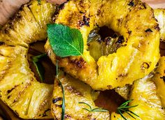 grilled pineapples with fresh herbs on a cutting board