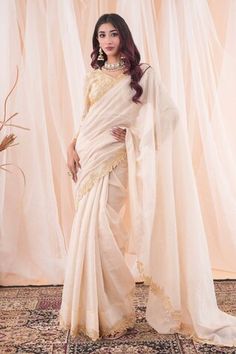 Ivory and beige saree with pearl and cutdana applique work border. Paired with an embroidered blouse with a tasseled hem. - Aza Fashions Elegant Beige Saree With Unstitched Blouse, Elegant Beige Blouse Piece With Traditional Drape, Elegant Beige Blouse With Traditional Drape, Elegant Beige Saree For Reception, Elegant Cream Blouse Piece For Diwali, Elegant Cream Pre-draped Saree With Sheer Dupatta, Elegant Beige Saree In Traditional Drape, Elegant Beige Saree With Traditional Drape, Elegant Beige Traditional Drape Saree