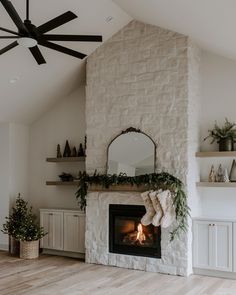 a living room with a fireplace and christmas stockings on the mantle