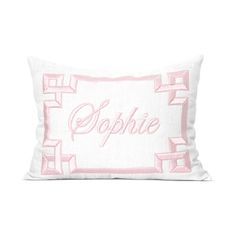 a pink and white pillow with the word ophie in cursive font