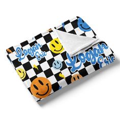 a black and white checkered blanket with smiley faces on it