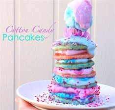 a stack of colorful donuts sitting on top of a white plate