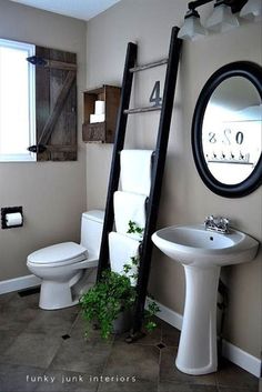 a bathroom with a ladder leaning against the wall next to a white toilet and sink