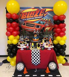 a birthday party with cars and balloons