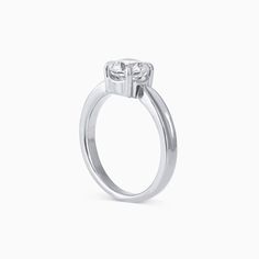 a three stone engagement ring with two diamonds on the top and bottom, set in 18k white gold