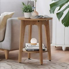 a wooden table with books on it and a potted plant next to the table