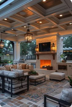 an outdoor living room with fireplace and seating