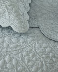 closeup of an upholstered quilt on a bed