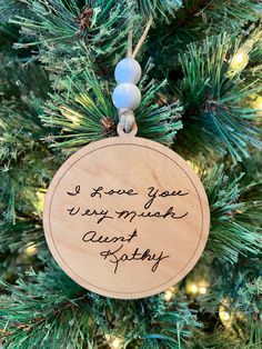 a wooden ornament hanging on a christmas tree with the words, i love you very much