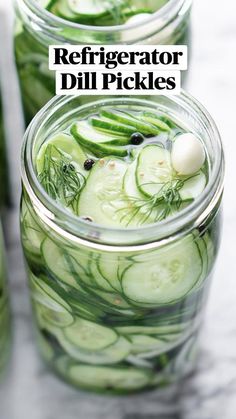 several jars filled with cucumbers and green onions on a table top next to each other