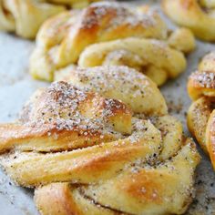 several pastries on a baking sheet covered in powdered sugar