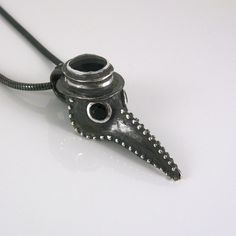 The Plague Doctor Pendant with Onyx Stones, a perfect memento for 2020 ~ Hand made to order ~ Sterling Silver ~ Onyx Gemstones ~ 20 inch Unseamed Sterling Silver Snake Chain ~ Stamped with Artist Signature and .925 ~ Please allow 5-10 business days to make pendant before shipping   ~Thank You! Also Available as a Ring: https://www.etsy.com/listing/848205859/plague-doctor-ring-with-onyx-stones?ref=shop_home_active_27&frs=1 Plague Doctor Jewelry, Symbolic Black Hand Cast Jewelry, Artisan Hand Cast Black Jewelry, Artisan Black Hand Cast Jewelry, Artisan Black Hand-cast Jewelry, Symbolic Hand-forged Black Jewelry, Symbolic Hand Forged Black Jewelry, Artisan Black Soldered Jewelry, Artisan Black Soldered Necklace