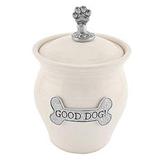 a white ceramic dog treat jar with a bone on the top and good dog written across it