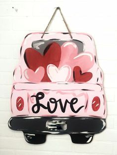 a pink suitcase with hearts painted on it