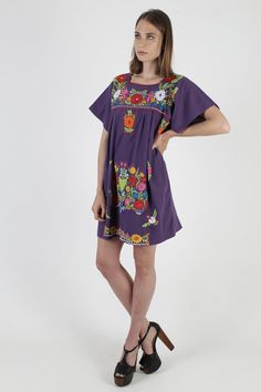 "Vintage traditional Mexican Puebla mini dress. Draped shift fit with fluttery cap sleeves. Purple cotton with bright floral embroidery. size estimate: M/L shoulders: 19.5\" bust: 44\" waist: - hips: 56\" total length: 33.5\" * Visit the shop * https://www.etsy.com/shop/americanarchive Model is 5'10\" Accessories not included." Mexican Dresses Traditional, Dress Traditional, Mexican Dress, Vintage Traditional, Traditional Mexican, Mexican Dresses, Bright Flowers, Traditional Dress, Traditional Dresses