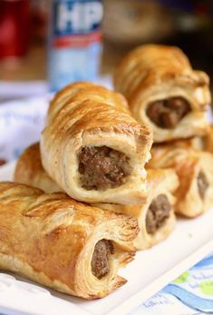 some sausage wrapped in bread on a white plate