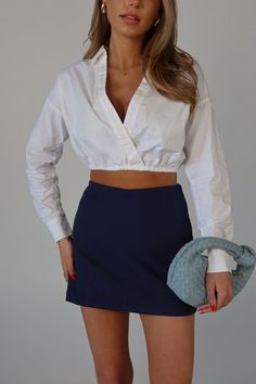 DETAILS: Our Zaria Collared Top is a cropped top with mid length sleeves and elastic hemline. This top features a vneckline with overlap detail and snap closure. This top features a bubble style relaxed fit. The rolled sleeve detail gives a this top an extra chic look. CONTENT & CARE: SELF: 97% Cotton, 3% Spandex SIZE & FIT: Model is 5'6" The model is wearing a size Small. Fits tru7e to size The Fabric has stretch STRETCH COTTON POPLIN ELASTIC BOTTOM OPENING WITH ROLL TAP SLEEVES SHIRT STRETCH P Chic Cropped Shirt With Cropped Hem For Spring, Chic Cropped Shirt For Day Out, Long Sleeve Cropped Shirt For Summer Day Out, Chic V-neck Crop Top For Day Out, Chic Cropped Shirt For Fall Day Out, Chic Fall Cropped Shirt For Day Out, Versatile V-neck Crop Top, V-neck Crop Top For Spring Workwear, Chic Workwear Top With Elastic Waistband