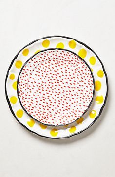 a white plate with yellow and red dots on it