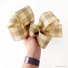 a hand is holding up a large bow