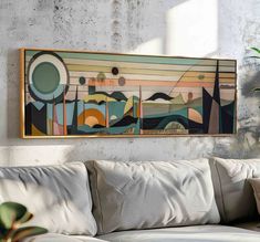 a painting hanging on the wall above a couch