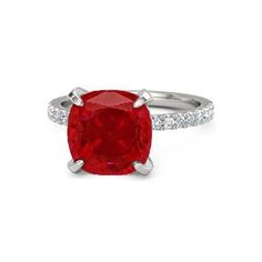 a ring with a red stone and diamonds on the sides, set in white gold