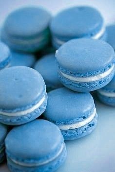 blue macaroons are stacked on top of each other