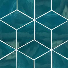 a blue tiled wall with white lines in the shape of hexagons on it