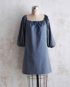 a mannequin wearing a blue dress with puffy sleeves