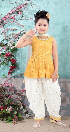 ABOUT THIS ITEM This girl's kurta Patiala set with dupatta is suitable for kids 4-14yrs age. Fabric Details: This is exclusive Bollywood-style party wear featuring excellent craftsmanship, beautiful embroidery, traditional prints, and vibrant colors. The Kurta Patiala set is made with lightweight georgette material that is skin-friendly, breathable, and comfortable to wear for kids. Age Group: 4 - 14 years. For best fitting, please take measurements for your child and refer to the size chart in the last picture before purchase. Wash care Instructions: Do not bleach, Iron at low heat, and Dry Clean ( preferred for first wash). Occasion: Birthday gift, Festive wear, Kids Diwali wear, Party and Casual wear, Wedding, and all special occasions. Package Includes: 1 Kurta +1 Patiala salwar + 1 du Traditional Bandhani Print Anarkali Set For Summer, Traditional Summer Bandhani Anarkali Set, Traditional Summer Anarkali Set With Bandhani Print, Bollywood Bandhani Print Sets For Summer, Festive Summer Bandhani Print Sets, Summer Festive Bandhani Print Sets, Yellow Sleeveless Set For Eid, Yellow Bandhani Print Salwar Kameez For Eid, Summer Bollywood Sets With Dabka Detailing