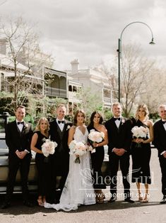 a group of people standing next to each other in front of a truck with flowers